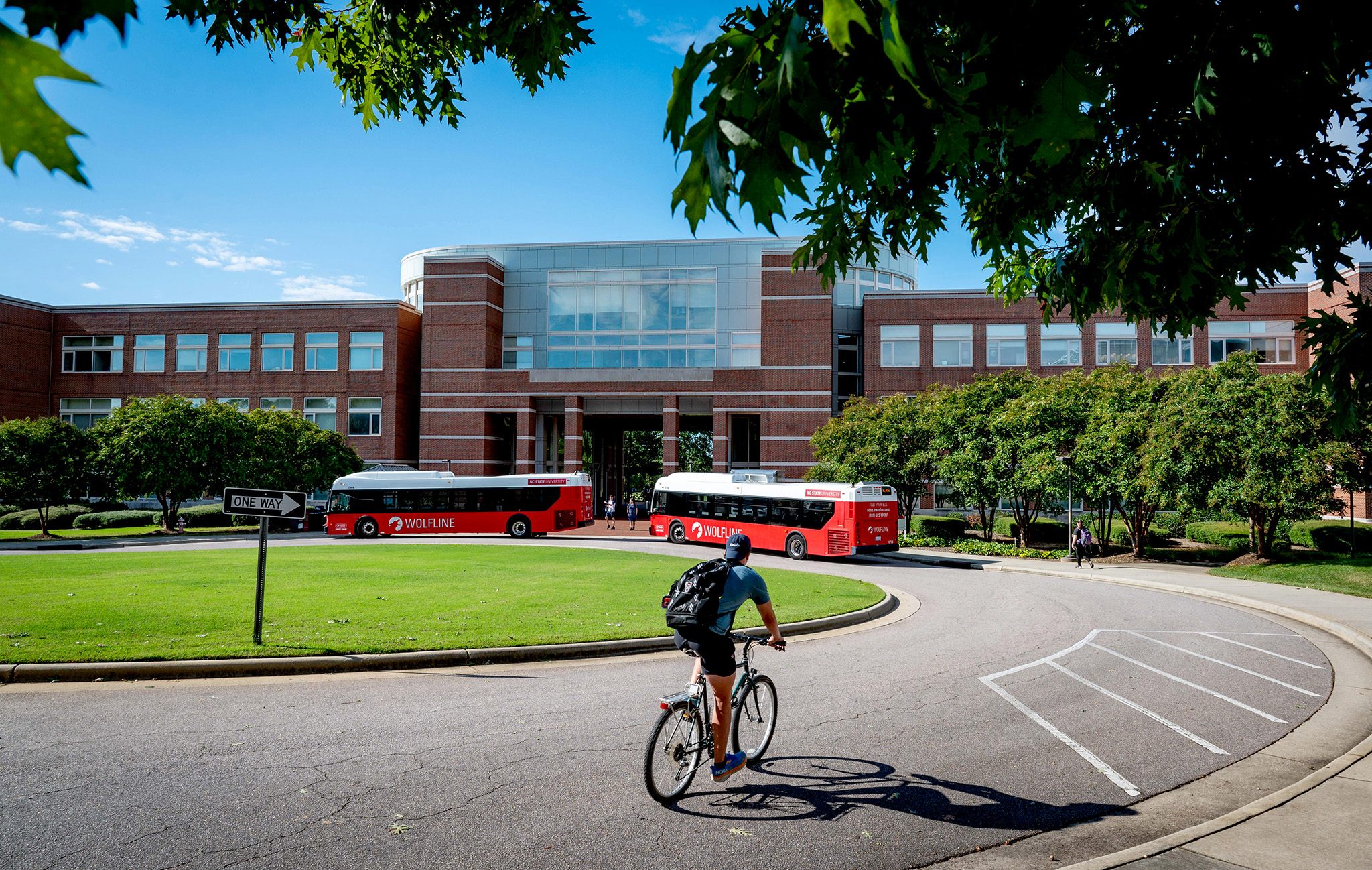 Students arrive at Engineering Building II in various forms of transportation on a late summer morning. 